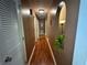 Hallway with wood floors and an archway; a small plant is set into a niche at 2671 Club Forest Se Ct, Conyers, GA 30013