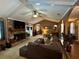 Open-concept living area with brick fireplace, arched doorways, and a view into the dining room at 2671 Club Forest Se Ct, Conyers, GA 30013