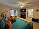 Comfortable main bedroom with colorful bedding, sitting area, mounted TV, and access to an en-suite bathroom at 2671 Club Forest Se Ct, Conyers, GA 30013