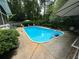 Enjoy this backyard pool surrounded by lush landscaping and ample seating at 2671 Club Forest Se Ct, Conyers, GA 30013