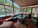 Relaxing screened-in porch with cozy seating, a glass top table, and a beautiful view of the backyard pool at 2671 Club Forest Se Ct, Conyers, GA 30013