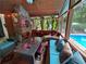 Enclosed porch featuring a brick fireplace, a table, comfortable seating, and a view of the backyard pool area at 2671 Club Forest Se Ct, Conyers, GA 30013