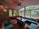 Inviting sunroom with brick accent wall, ample seating, and a view of the greenery at 2671 Club Forest Se Ct, Conyers, GA 30013