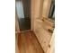 Bathroom has double sinks on a white vanity with stylish fixtures and wood-look vinyl flooring at 2751 Penwood Pl, Lithonia, GA 30058