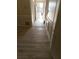 An entryway has wood-look flooring, wall paneling and white trim offering a welcoming and stylish transition at 2751 Penwood Pl, Lithonia, GA 30058