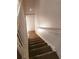 A carpeted stairway with white rails adds charm to the home's interior, connecting different levels at 2751 Penwood Pl, Lithonia, GA 30058