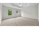 Large bedroom with neutral carpet, a ceiling fan, and two windows at 3340 Ivey Rdg, Buford, GA 30519