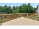 Sunny wooden deck overlooking a green backyard and mature trees at 3340 Ivey Rdg, Buford, GA 30519