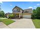 Charming two-story home with a well-manicured lawn, a two-car garage, and a welcoming front porch at 3340 Ivey Rdg, Buford, GA 30519
