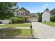 Inviting two-story home featuring a well-maintained lawn, a two-car garage, and a charming front porch at 3340 Ivey Rdg, Buford, GA 30519