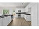 Modern kitchen with stainless steel appliances, white cabinetry, and ample counter space at 3340 Ivey Rdg, Buford, GA 30519