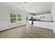 Open-concept kitchen and dining area with stainless steel appliances, white cabinets, and lots of natural light at 3340 Ivey Rdg, Buford, GA 30519