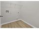 Functional laundry room with a metal storage rack and wood-look flooring at 3340 Ivey Rdg, Buford, GA 30519