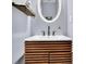 Modern bathroom features white countertop, wooden vanity, and oval mirror at 541 Lantern Wood Dr, Scottdale, GA 30079