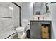 Bathroom features a marble tiled shower, toilet, and vanity with storage space at 541 Lantern Wood Dr, Scottdale, GA 30079