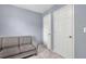 Neutral bedroom featuring a cozy couch and two white doors with brass hardware at 541 Lantern Wood Dr, Scottdale, GA 30079