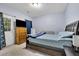 Bedroom features a bed, nightstand, dresser, TV, curtains, carpet, and blue paint at 541 Lantern Wood Dr, Scottdale, GA 30079