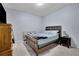 Bedroom features a bed, nightstand, light, dresser, carpet, and blue paint at 541 Lantern Wood Dr, Scottdale, GA 30079