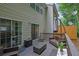 Relaxing deck with wicker furniture, an umbrella, and sliding door access to the home at 541 Lantern Wood Dr, Scottdale, GA 30079
