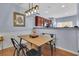 Dining room features a wood table with metal chairs, and decorative lighting at 541 Lantern Wood Dr, Scottdale, GA 30079