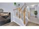 Bright entryway features hardwood floors, staircase, white railing, and modern light fixture at 541 Lantern Wood Dr, Scottdale, GA 30079
