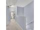 Light and airy upstairs hallway with a view into a sunlit room and staircase on the right at 541 Lantern Wood Dr, Scottdale, GA 30079