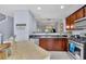 Modern kitchen with wood cabinets, stainless steel appliances, and a center island at 541 Lantern Wood Dr, Scottdale, GA 30079