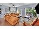Living room with fireplace, large sectional sofa, hardwood floors, and sliding glass doors to back deck at 541 Lantern Wood Dr, Scottdale, GA 30079