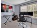 Office space featuring a desk, chair, keyboard, monitors, and elephant art piece at 541 Lantern Wood Dr, Scottdale, GA 30079