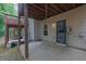 Covered concrete patio under an elevated wood deck at 541 Lantern Wood Dr, Scottdale, GA 30079
