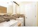 Bathroom featuring a double vanity, stylish backsplash, and great lighting at 5867 Trent Walk Dr, Lithonia, GA 30038