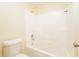 Bathroom featuring a tub-shower combo with clean, white tile surround at 5867 Trent Walk Dr, Lithonia, GA 30038
