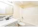 Updated bathroom featuring tub and shower combo, white tiling and updated vanity at 5867 Trent Walk Dr, Lithonia, GA 30038