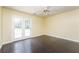 Bright bedroom featuring hardwood floors and direct access to the outdoors at 5867 Trent Walk Dr, Lithonia, GA 30038
