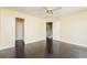 Bright bedroom with dark hardwood floors, view to stairway and closet at 5867 Trent Walk Dr, Lithonia, GA 30038