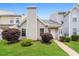 Charming townhouse featuring lush front lawn and neatly trimmed shrubbery at 5867 Trent Walk Dr, Lithonia, GA 30038