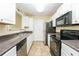 Functional kitchen with white cabinets, tile floors and modern appliances at 5867 Trent Walk Dr, Lithonia, GA 30038