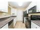 Well-lit kitchen with modern appliances, ample cabinet space, and a double sink at 5867 Trent Walk Dr, Lithonia, GA 30038