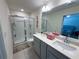 Bathroom featuring double sinks, a glass enclosed shower, and a large mirror to enhance the space at 82 Auburn Run Ln, Auburn, GA 30011