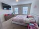 Bright bedroom with large television, plush carpet, and abundant natural light at 82 Auburn Run Ln, Auburn, GA 30011