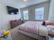 Bright bedroom with large television, plush carpet, and abundant natural light at 82 Auburn Run Ln, Auburn, GA 30011