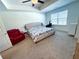 Spacious bedroom featuring a ceiling fan and large window for natural lighting at 82 Auburn Run Ln, Auburn, GA 30011
