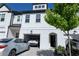 Charming townhouse with white brick and siding and attached garages at 82 Auburn Run Ln, Auburn, GA 30011
