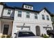 Charming townhouse with white brick and siding and attached garages at 82 Auburn Run Ln, Auburn, GA 30011