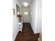 Entry hallway with wood floors, a decorative table and mirror creating a welcoming space at 82 Auburn Run Ln, Auburn, GA 30011