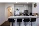 Open kitchen view with stainless steel appliances, breakfast bar, and pendant lighting at 82 Auburn Run Ln, Auburn, GA 30011