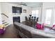 Bright living room with a fireplace, large windows, and adjacent dining area at 82 Auburn Run Ln, Auburn, GA 30011