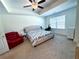 Bright main bedroom with a ceiling fan, carpet flooring, and large window providing natural light at 82 Auburn Run Ln, Auburn, GA 30011