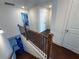 Open staircase with dark wood railing and carpeted steps leading to an upper level landing at 82 Auburn Run Ln, Auburn, GA 30011