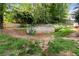 Natural backyard setting with segmented stone retaining walls and lush greenery at 2280 Wildwood Lake Dr, Suwanee, GA 30024
